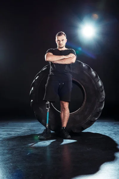 Paralympic sportsman leaning on tire — Stock Photo, Image