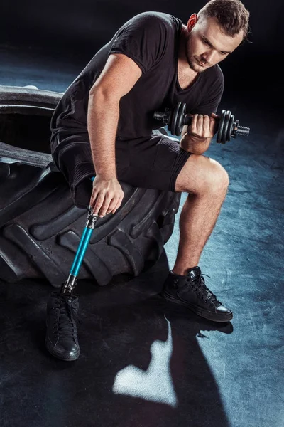 Paralympic sportsman exercising with dumbbell — Stock Photo, Image