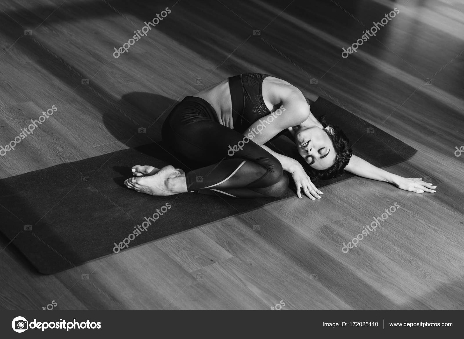 Woman in sportswear sleeping in yoga mat Stock Photo by