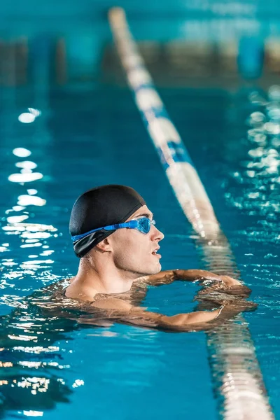 swimmer in swimming cap and goggles