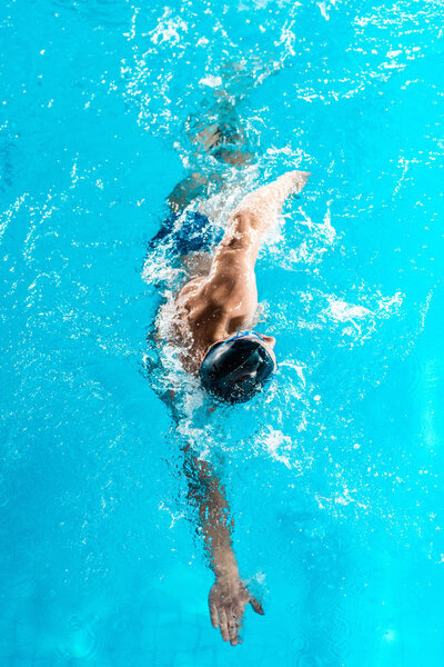 swimmer swimming in pool 