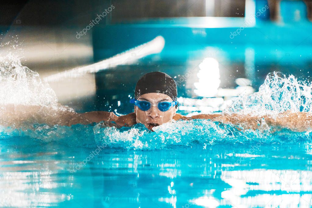 professional swimmer in competition pool