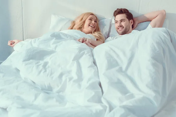 Couple relaxing in bed at morning — Stock Photo, Image