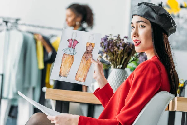 Asian fashion designer with sketches — Stock Photo, Image