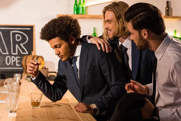 Businessmen drinking whiskey in bar — Stock Photo, Image