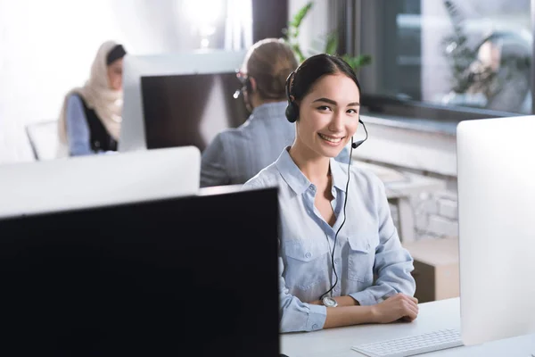 Asian call center operator in headset — Stock Photo, Image