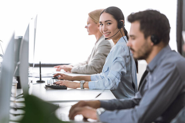 smiling asian call center operator