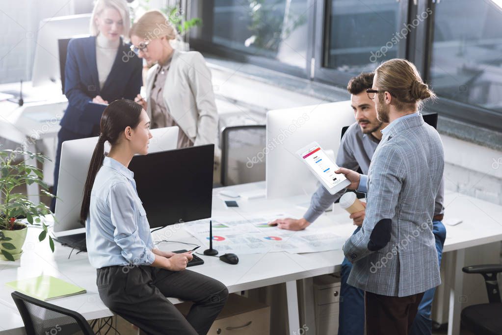 Selective focus of businesspeople having discussion at workplace in office