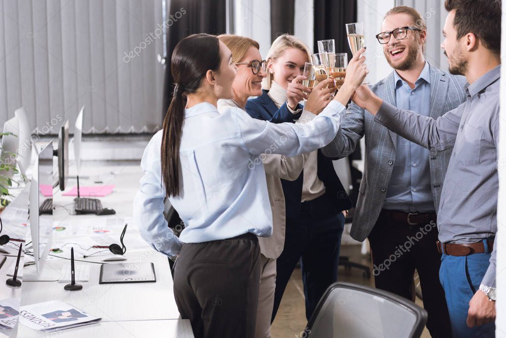 businesspeople clinking glasses of champagne