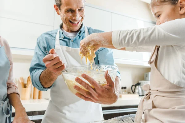 Kid with father mixing dough — Stock Photo, Image