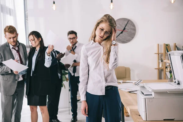 Young manageress with headache waiting near copier at office — Stock Image Young Manageress Headache Waiting Copier Office Stock Photo