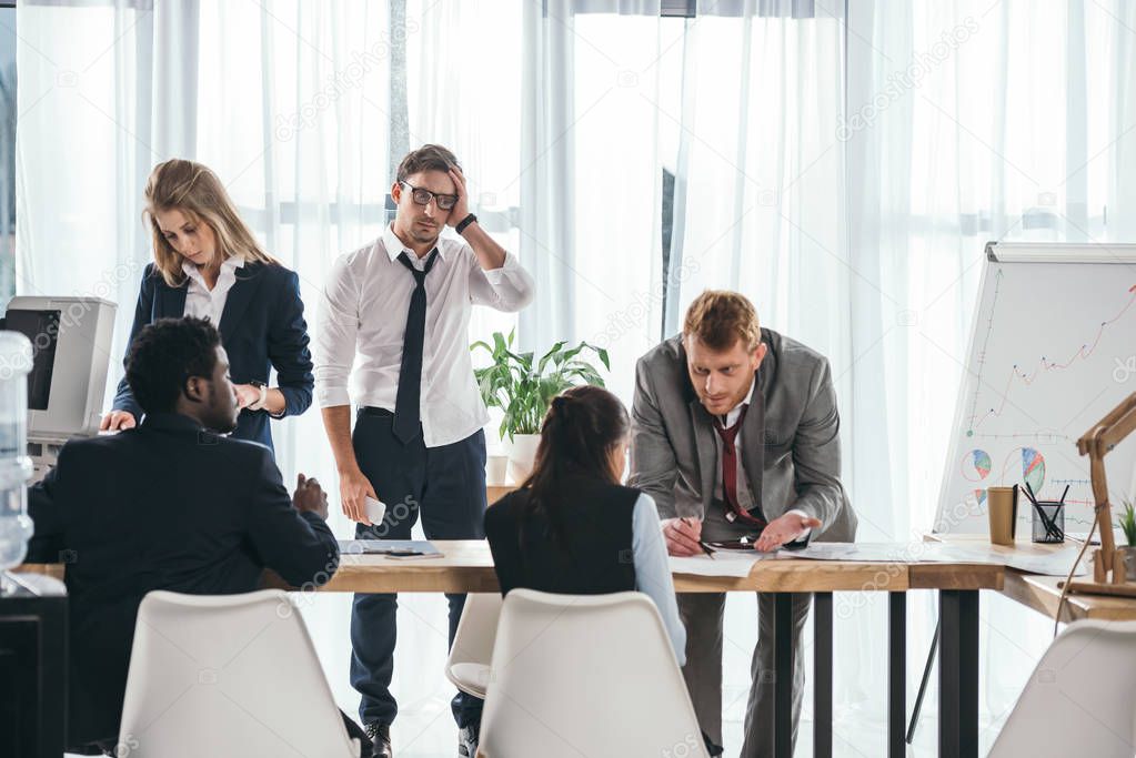 group of businesspeople having conversation at office