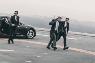 bodyguards protecting businessman on his way from car