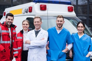 happy ambulance doctors working team standing in front of car clipart