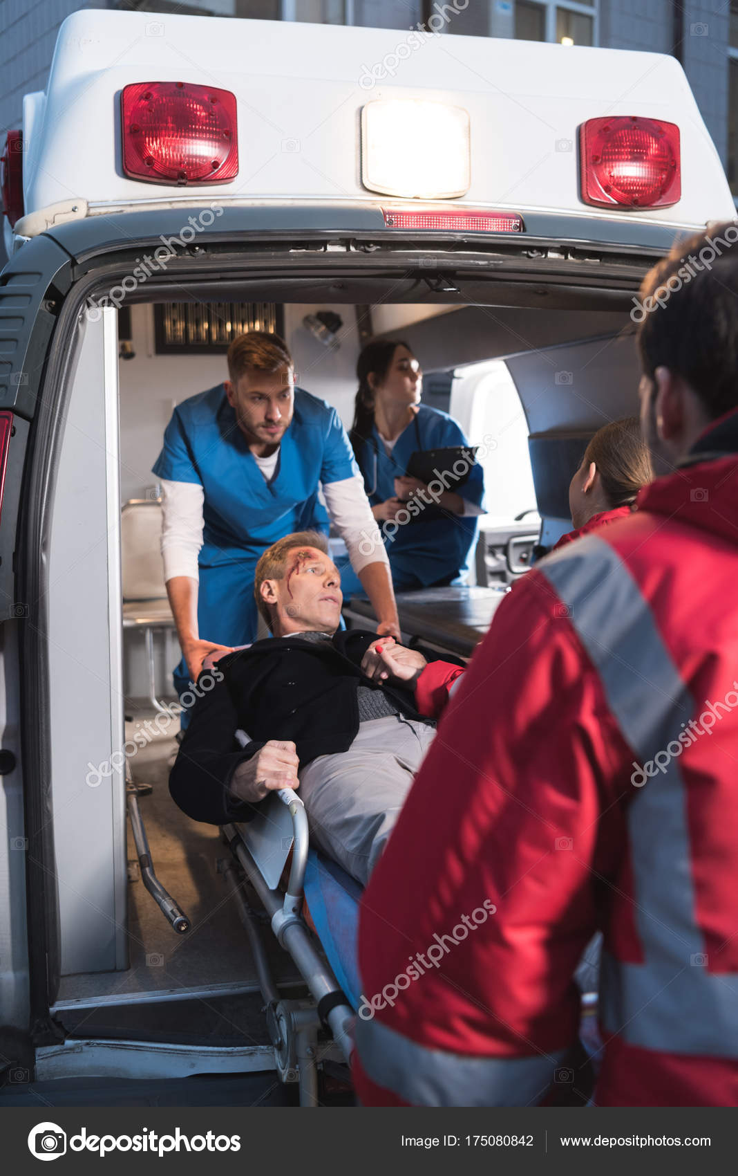 Paramedics Moving Injured Man Ambulance Stock Photo by ©ArturVerkhovetskiy  175080842