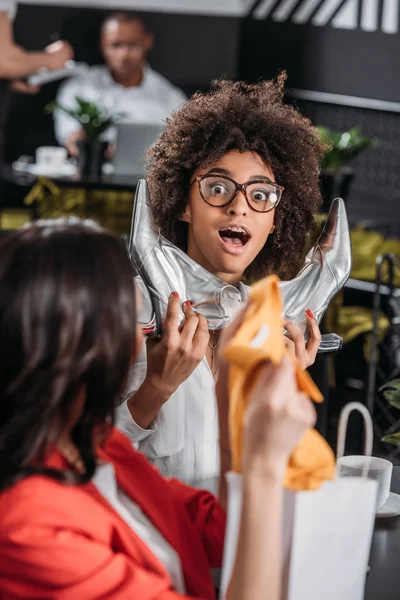 Shocked Young Woman Glossy Silver Boots — Free Stock Photo