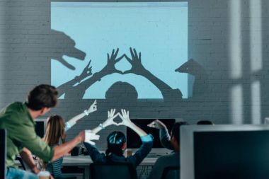 young people playing with shadows after work in modern office clipart