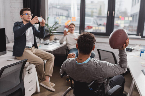 Men playing with ball in modern office