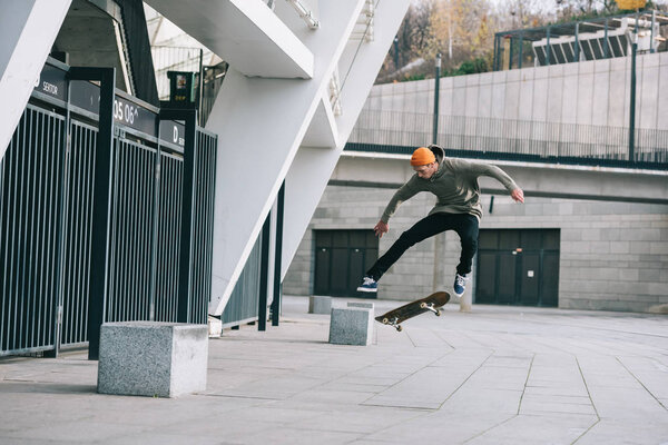 skateboarder performing jump trick in urban location