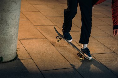 cropped shot of skateboarder preforming balance trick clipart