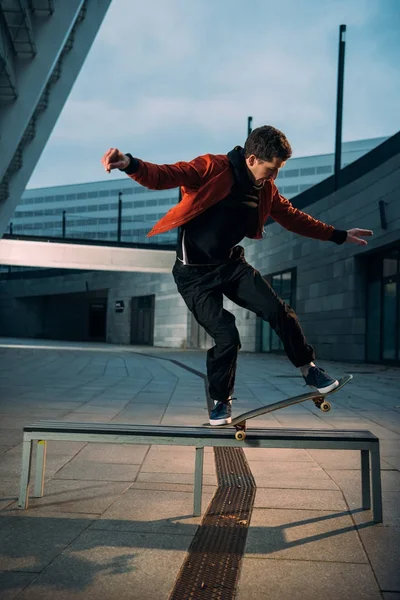 Mladý Americký Skateboardista Provádění Trik Lavičce — Stock fotografie
