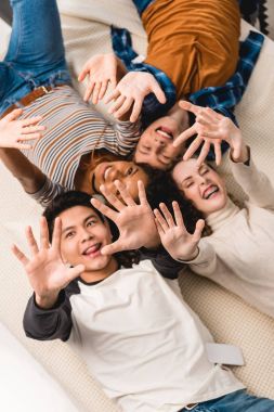 overhead view of smiling multiethnic teens waving hands clipart