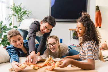 happy multicultural teenagers taking pizza clipart