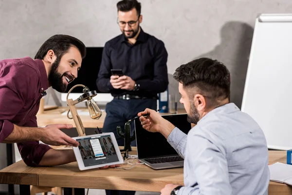 Smiling Businessman Showing Colleagues Linkedin Page Tablet — Stock Photo, Image