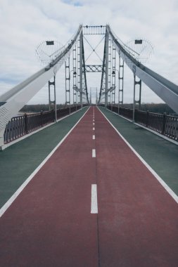 empty pedestrian bridge on cloudy autumn day clipart