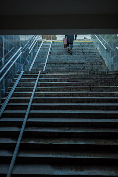 lonely man walking upstairs out of underground