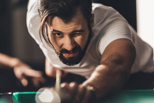 handsome caucasian man playing in pool