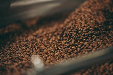 selective focus of coffee beans roasting process clipart