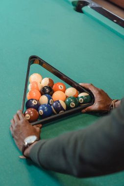 cropped image of male hands forming set of billiard balls by triangle clipart