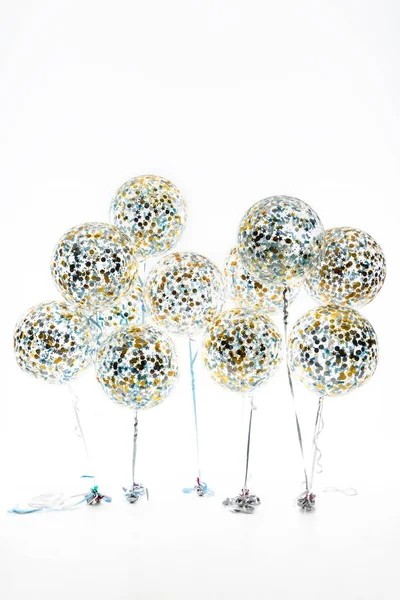 big balloons with golden and blue confetti and stars, isolated on white