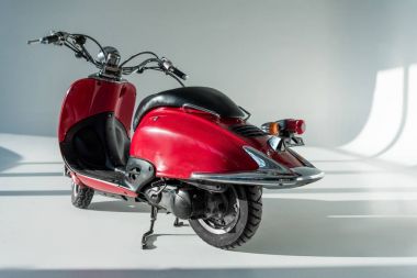 close up view of red vintage scooter in studio clipart