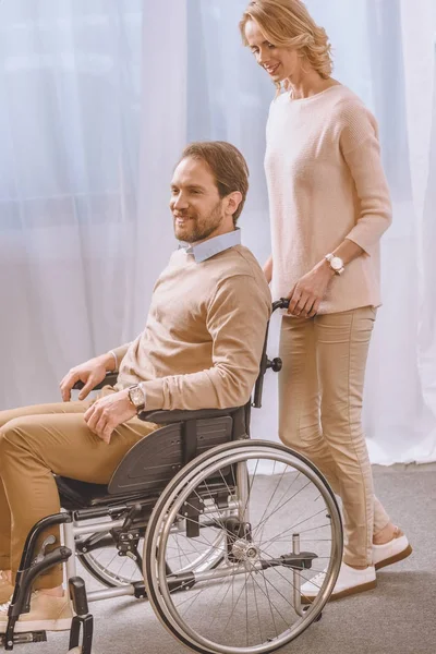 Wife Carrying Happy Husband Wheelchair — Free Stock Photo