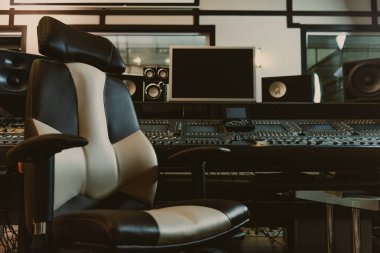 armchair in front of graphic equalizer at recording studio clipart