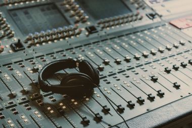 headphones on graphic equalizer at recording studio clipart