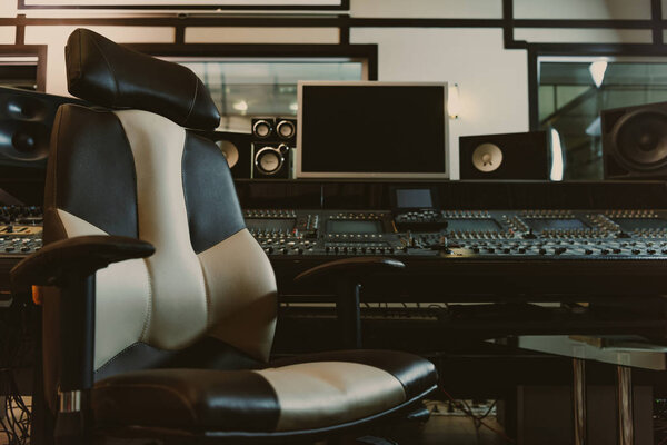 armchair in front of graphic equalizer at recording studio