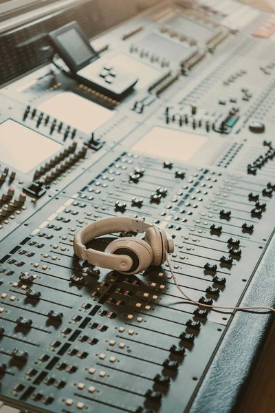 headphones on graphic equalizer at recording studio