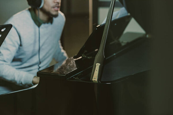 cropped shot of african american man playing piano