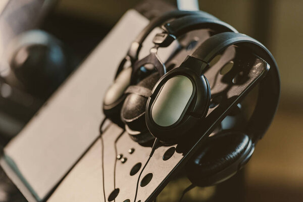 close-up shot of headphones hanging on music stand
