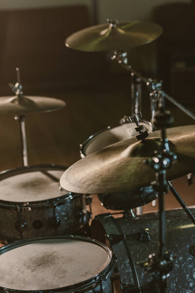 close-up shot of drum set under spotlight on stage