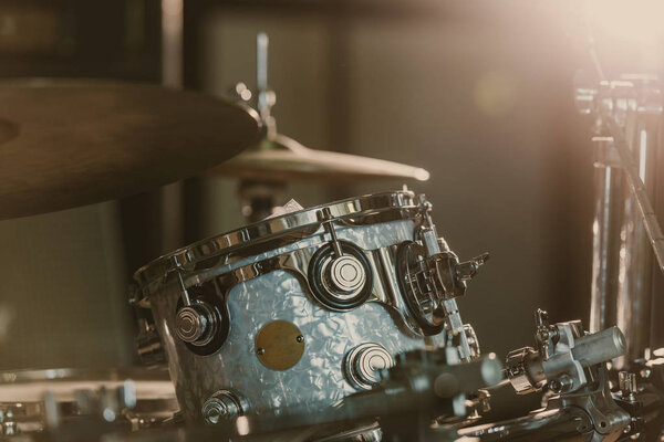 close-up shot of drum set under spotlight on stage