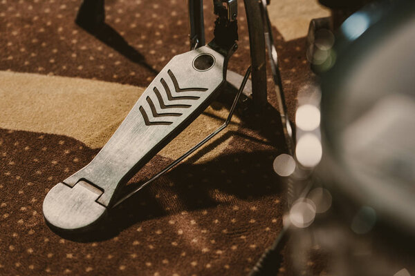 close-up shot of drum pedal on carpet