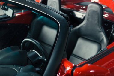 cropped shot of new red sport car interior clipart