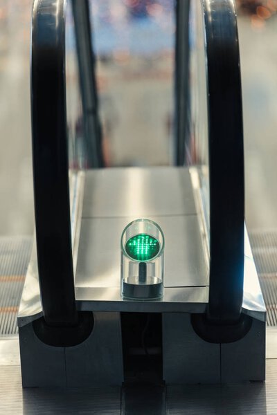 close-up shot of green light of escalator indoors