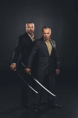 businessmen with katana swords isolated on black clipart
