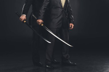cropped shot of yakuza members with katana swords isolated on black clipart