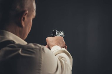 close-up shot of security man aiming with gun